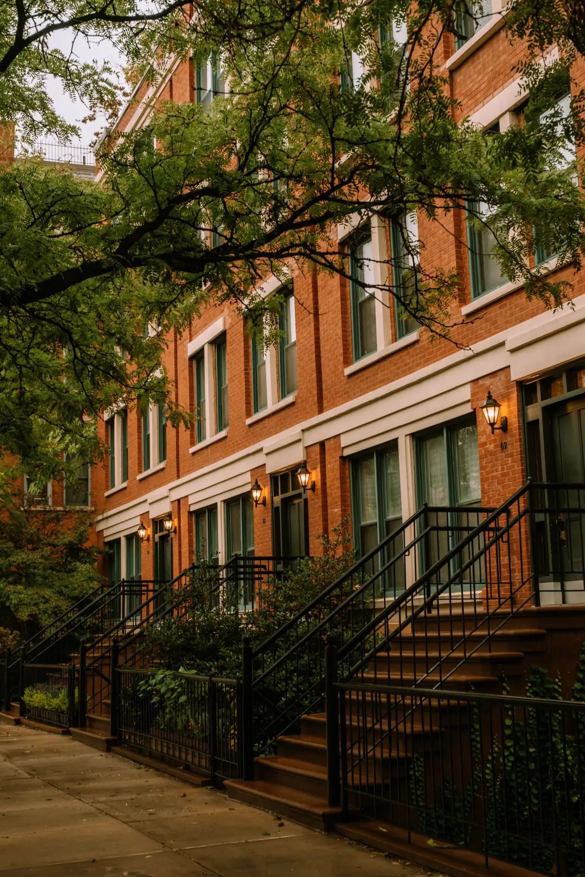Red brick townhouses with front stairs and lanterns