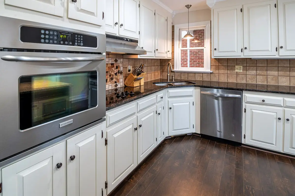White kitchen with cabinets, an oven and a dishwasher