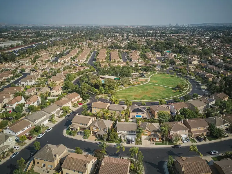 Aerial view of a suburban neighborhood around a green park